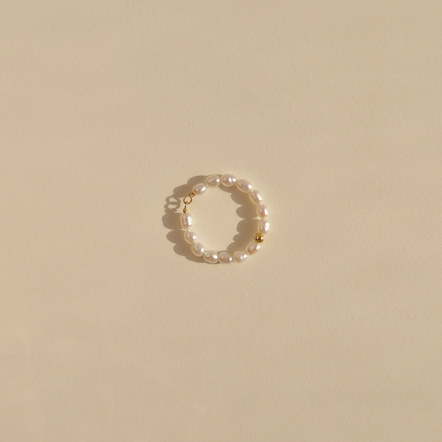 Pearl ring with a gold bead