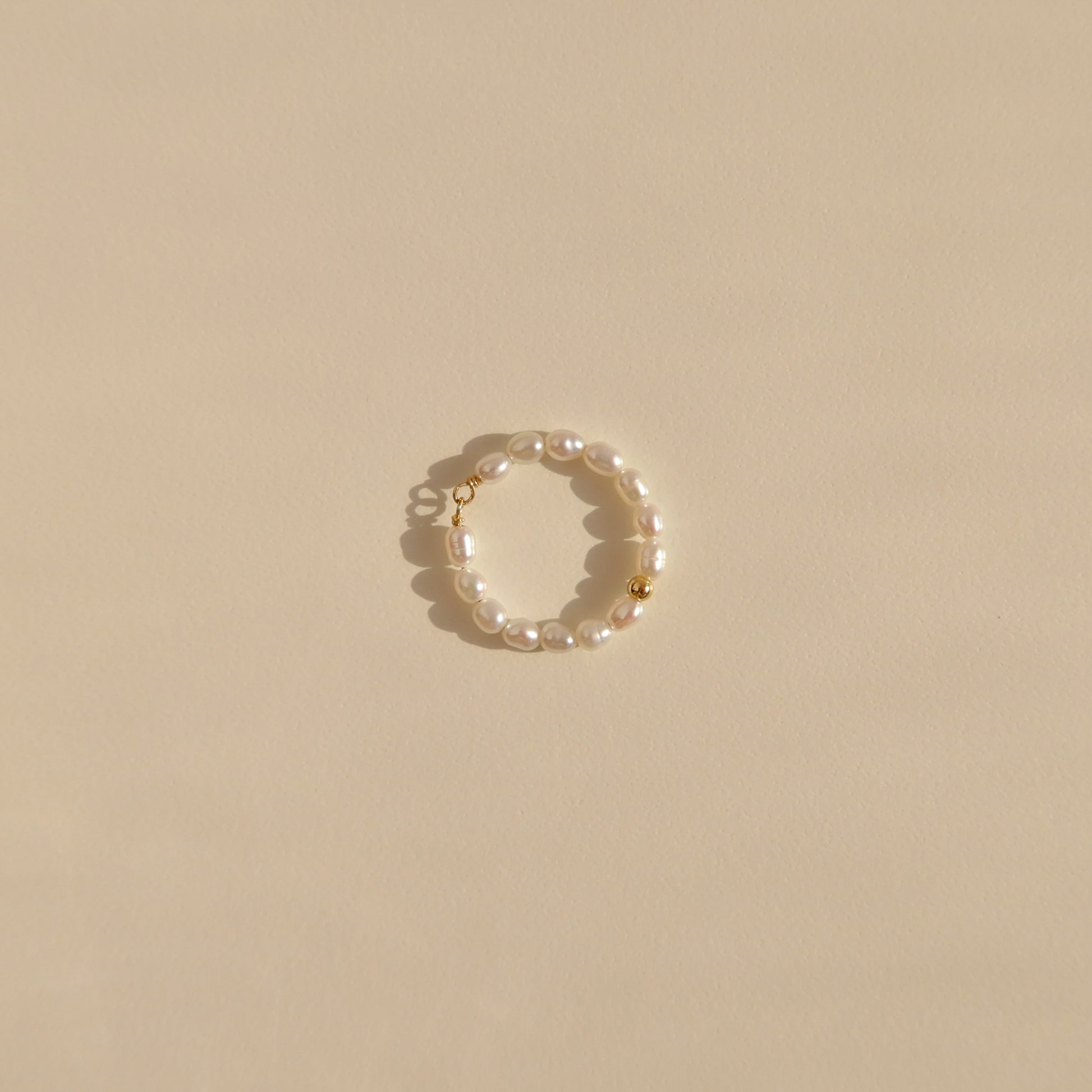 Pearl ring with a gold bead