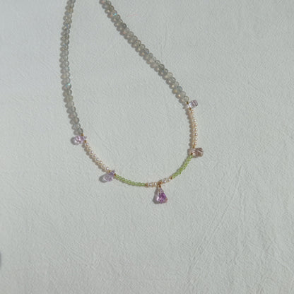 Necklace with gemstones on a light gray background
