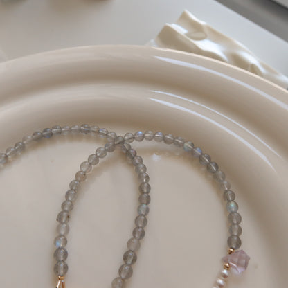 Beaded moonstone necklace on a white ceramic plate