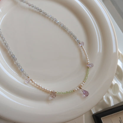 Necklace with moonstone, freshwater pearls and ametrine stones on a white plate