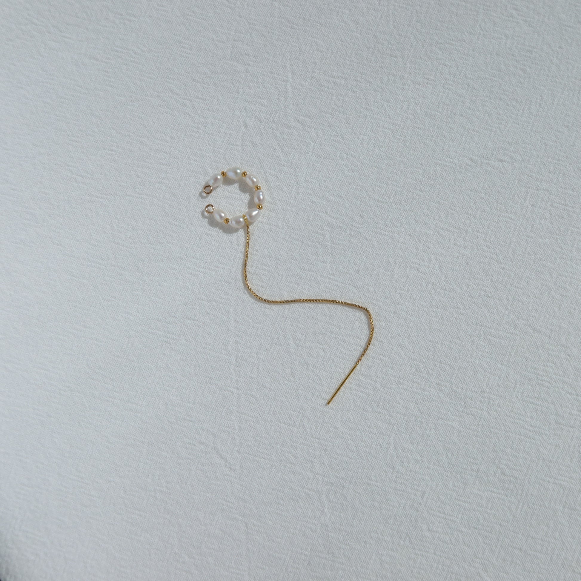 Single earring on a light gray background