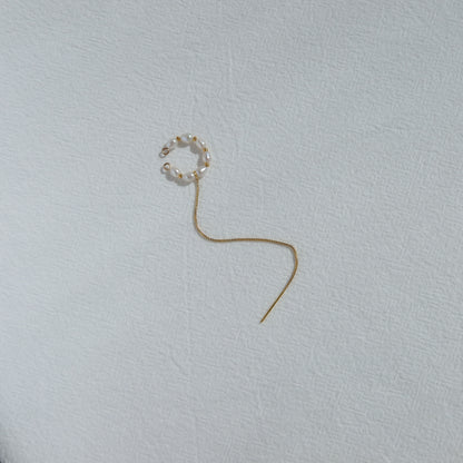 Single earring on a light gray background